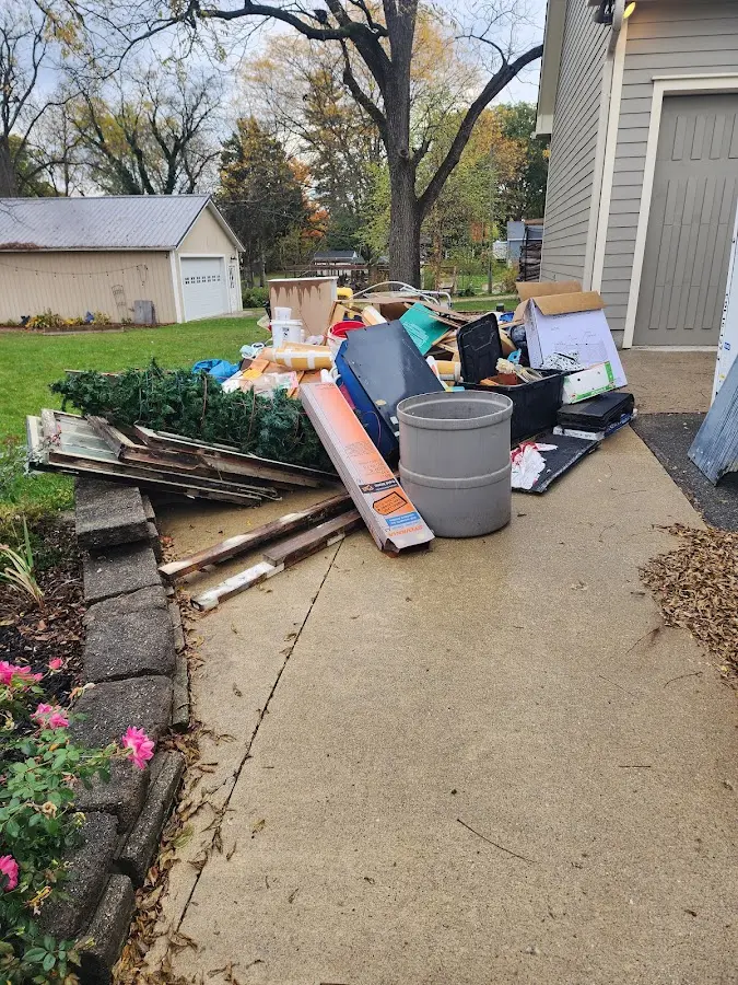Dumpster being loaded with debris for Estate Cleanout Dumpster Rental in Asbury Park